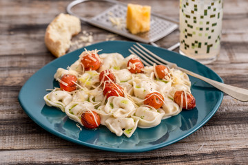 Four cheese capelettis with caprese sauce