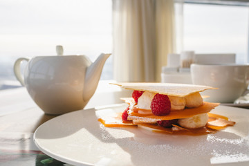 Promotion for desserts in a cafe. Crispy and fresh millefeuille cake with fresh berries