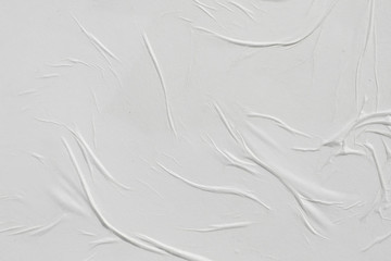 Naklejka premium Crumpled white paper. Abstract background for the designer.