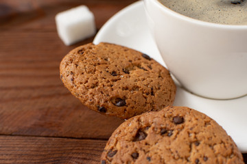 Espresso coffee on a wooden background with cookies. Still-life. Selective focus.