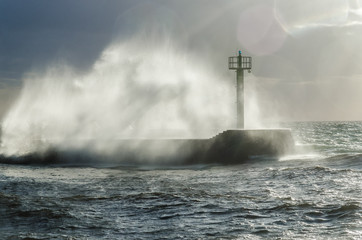 Fototapeta na wymiar HURRICANE BY THE SEA - Storm waves crashing on the breakwater in the port