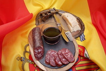 Products from Spain, photograph of Iberian sausage table with tray and glass of red wine, old...