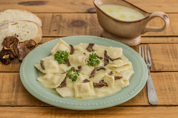 ricotta ravioli with mushroom ragout on a wooden table
