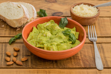 Vegetable ravioli with zucchini and mint pesto on a wooden table