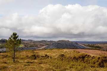 Fototapeta premium Stockpile of human waste covered by plastic sheeting and tires in Sobrado Spain