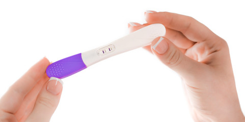 Pregnancy positive test in female hand on blurred medical background. Maternity new life born.
