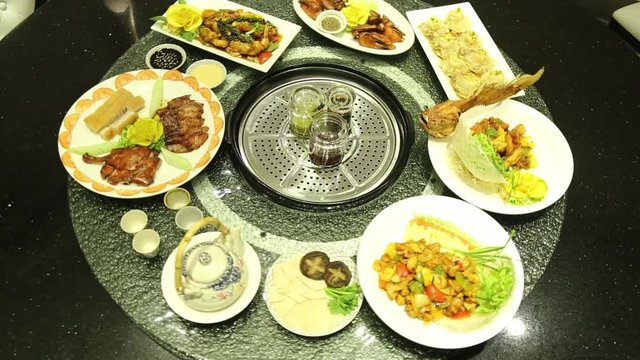 Banquet Of Asian Food, Turning On Lazy Susan Table At Asian Restaurant