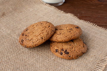 Homemade cow's milk with cookies on a wooden background. Rustic style. Still-life.