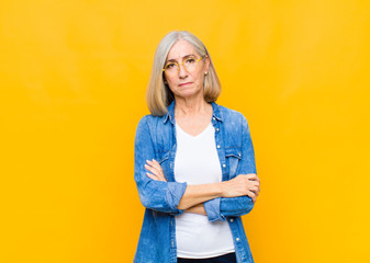senior or middle age pretty woman feeling displeased and disappointed, looking serious, annoyed and...