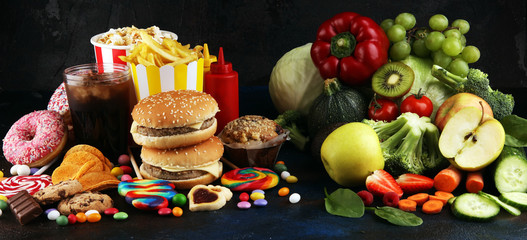 healthy or unhealthy food. Concept photo of healthy and unhealthy food. Fruits and vegetables vs donuts,sweets and burgers