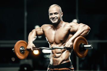 Naklejka na ściany i meble Bodybuilder athletic man workout muscles exercise.
