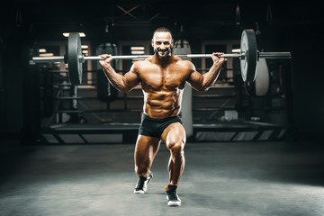 Fototapeta na wymiar bodybuilder fitness man pumping up legs muscles