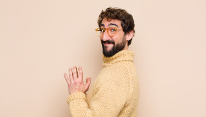 young cool man feeling proud, mischievous and arrogant while scheming an evil plan or thinking of a...