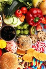 Obraz na płótnie Canvas healthy or unhealthy food. Concept photo of healthy and unhealthy food. Fruits and vegetables vs donuts,sweets and burgers