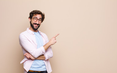 young bearded man expressing a concept against flat wall