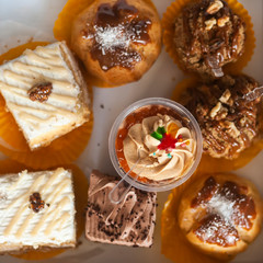 Tasty pastry cakes on background
