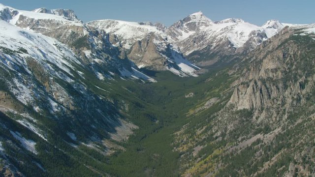 The snowcapped peaks, steep cliffs and dense forests of the Absaroka mountain Range near Yellowstone National Park