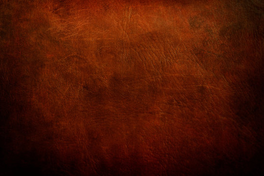 old red leather, grunge background with dark vignette borders