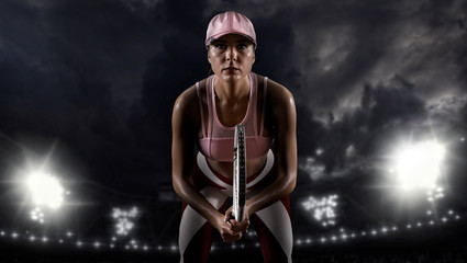 Fototapeta na wymiar Female tennis player on dark