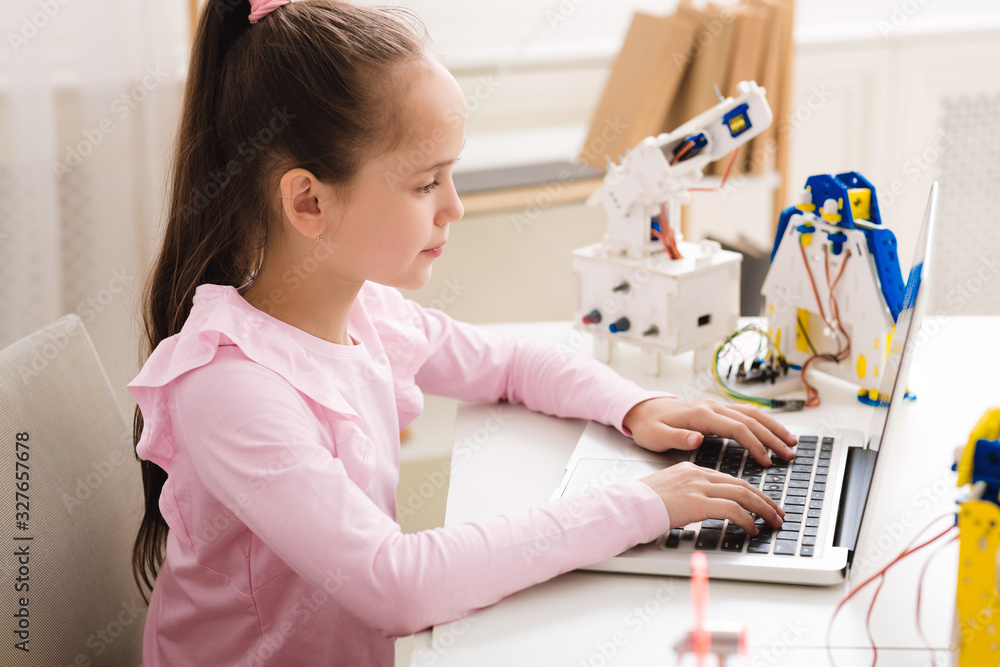 Poster Clever girl programing and building robot in after school class
