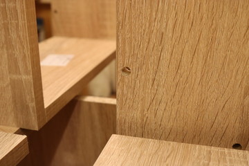 An element of a wooden structure with a round through cut on the background of other elements.