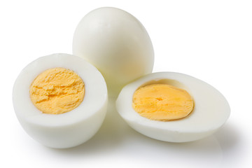 boiled peeled eggs on a white background, one whole egg two eggs are cut in half, the yolk is visible