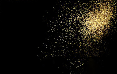 Black background with golden sparkles. Blurred effect. Concept for festive background