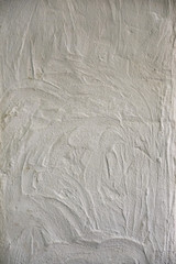 Textured white wall with wave-like stains. Texture wallpaper.