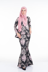 Beautiful female Asian model in various poses wearing a Malaysian traditional wear isolated on white background. Beauty and fashion concept. Full length portrait