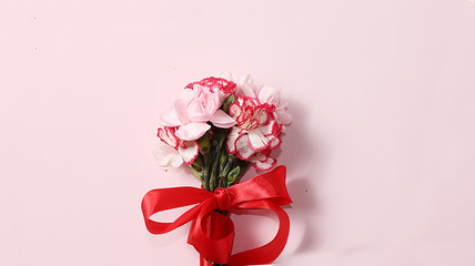 Arrangement of flowers on a pink isolated background, place for text, flat lay. Creative modern bouquet, minimal holiday and spring concept. Greeting card for Women's Day  ,happy birthday, wedding,