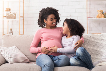 Happy Afro Mom And Daughter Bonding Together On Couch At Home