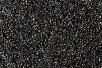 Foam rubber texture close up. High quality macro texture of dark grey paralon sponge.