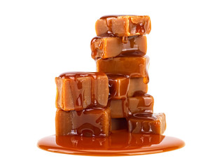Caramel candies and caramel sauce isolated on a white background