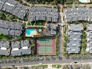 Fototapeta na wymiar Aerial view of condo community with tennis court and pool in Solana Beach, South California. USA