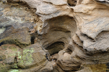 Cave and holes in the rocks with organic shapes due to the natural erosion of the sea water - cavern wallpaper