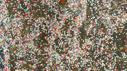 colorful confetti texture on the ground made of small paper squares - festival or celebration party background