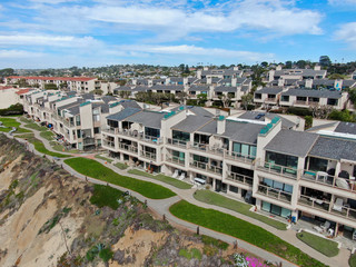 Fototapeta premium Aerial view of wealthy condy community on the cleef next to the ocean in south california, USA