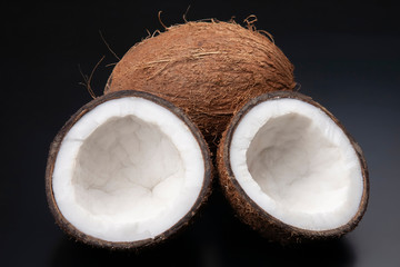 cut fresh coconut on a dark background. vitamin fruits. healthy food
