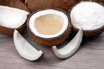 Sliced ​​coconut with natural milk and coconut on a wooden board. Vitamin Fruits. Healthy food.