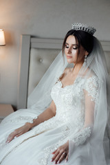 Happy young bride resting in the room before the wedding