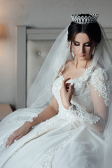 Happy young bride resting in the room before the wedding