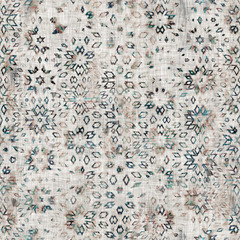 Seamless mixed media collage design in old aged worn look. Variable kaleidoscope design overlaid, mottled, and distressed on fabric texture. Seamless repeat raster jpg pattern swatch.