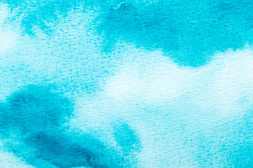 Abstract blue watercolor background. The color splashing on the paper. Hand drawn.