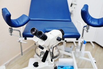 doctor's office for women's health-gynecological microscope and chair close-up.