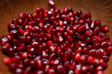 pomegranate seeds in a brown plate