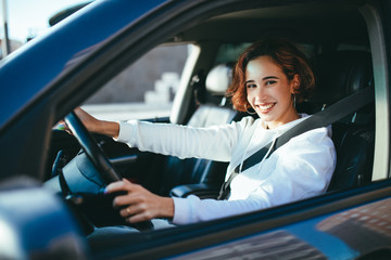 young girl driving a car