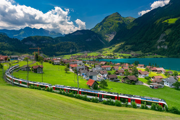 Famous electric red tourist panoramic train in swiss village Lungern, canton of Obwalden,...