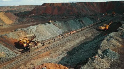 iron ore excavator on a train in a quarry.