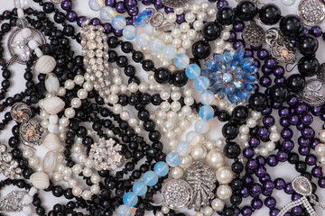 Jewel set. Beautiful fashion jewelry with precious shiny stones, pearls and blue diamonds for women. Many jewelery background from yellow and white gold