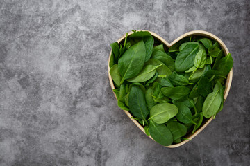 Fresh spinach leaves or spinach salad close up, background. Copy space.